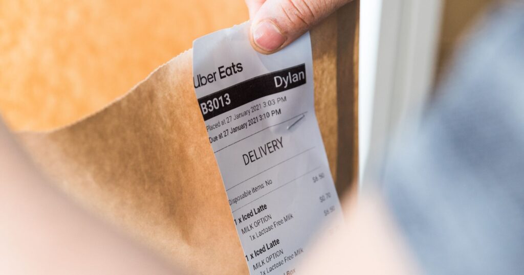brown paper bag with uber eats delivery receipt attached