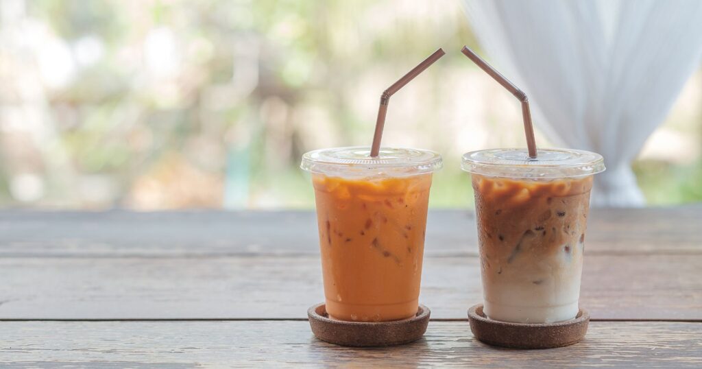 two iced coffees on a wooden table, canada plastic ban overturned